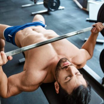 how to perform the bench press | man doing bench press in gym