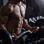 Concentric, Eccentric, and Isometric Contractions | man in gym biceps curl